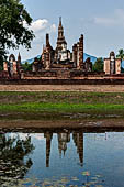 Thailand, Old Sukhothai - Wat Mahathat, the vihan with a seated Buddha statue. 